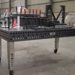 Tenaxis welding table showing adjustable stainless steel legs and toolkits.