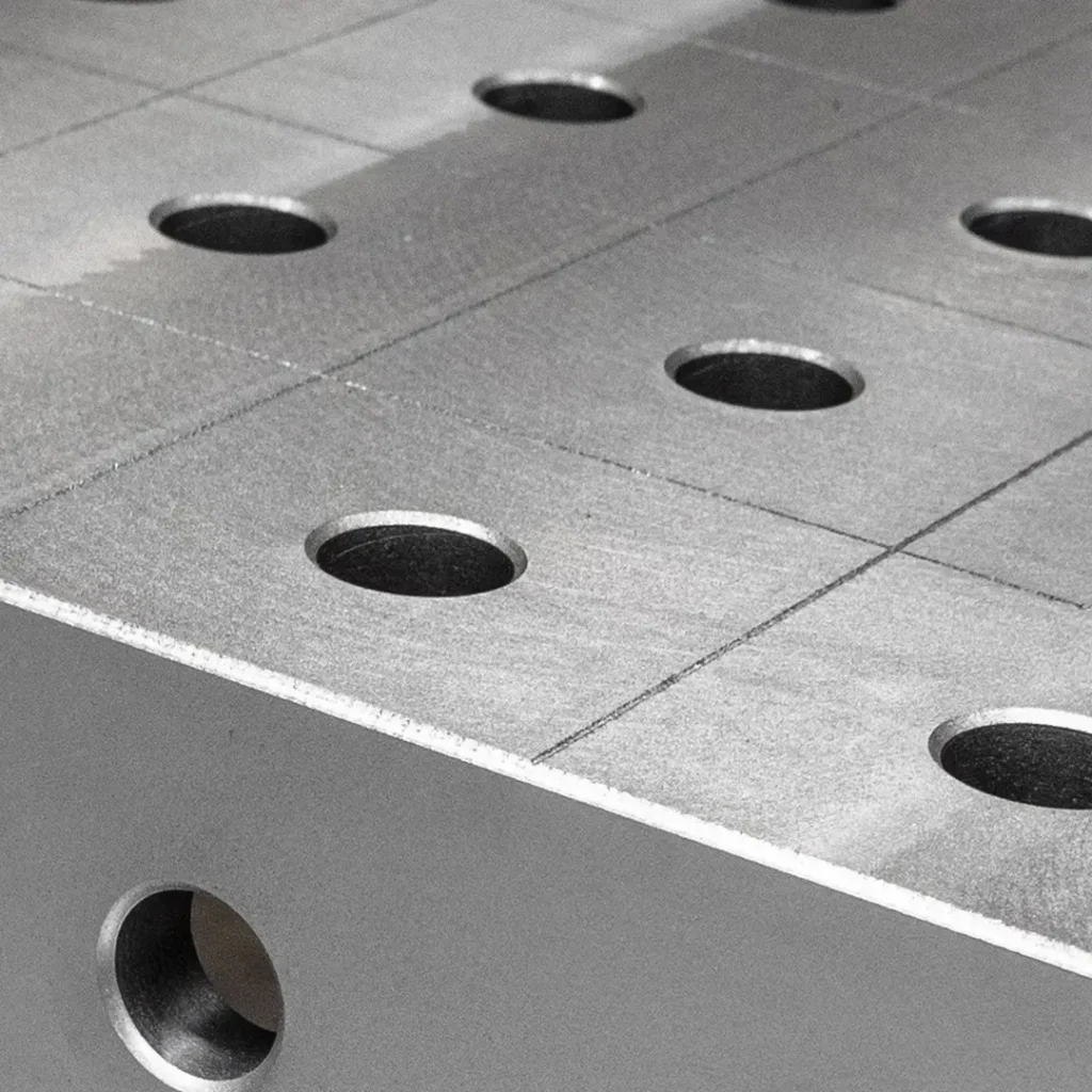 Close-up of a Tenaxis raw cast iron welding table