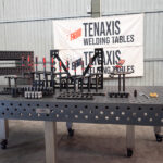Perspective view of 1500x3000mm modular welding table and industrial workholding tools.