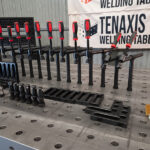 Close-up of workholding clamps and square tools on a 1500x3000mm raw cast iron table
