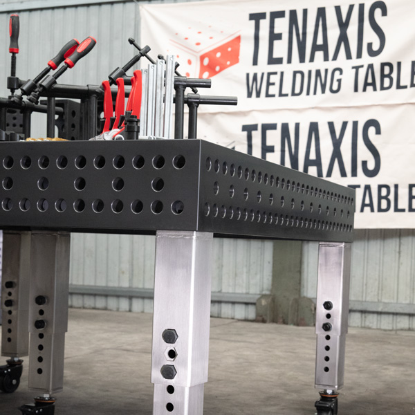 Side angle of a 1500x3000mm nitrided steel welding table with stainless steel adjustable legs and casters.