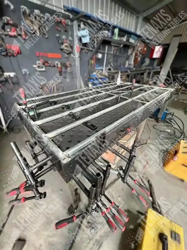Tenaxis welding table utilizing side-plate clamping for a complex multi-part metal assembly project.