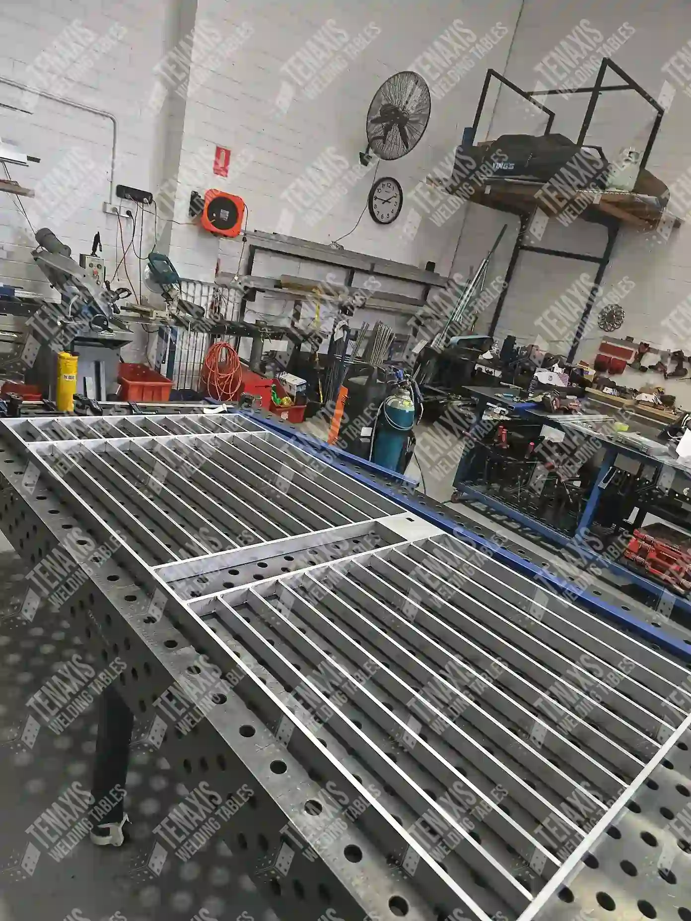 Large-scale commercial security fence being squared up on a 1500x3000mm welding table