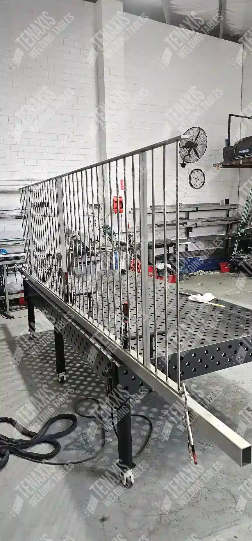 Fabrication of a decorative metal railing using welding clamps and stops for repeatable, accurate spacing.